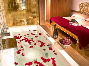 a room with a bath tub with red flowers on it at Malostranská Residence in Prague