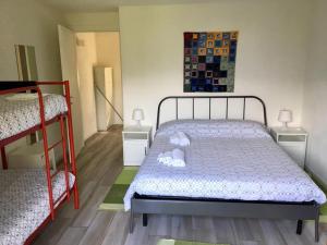 a bedroom with a bed and two bunk beds at Tenuta Pozzi in Colico