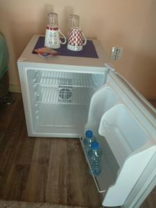 an open refrigerator with two bottles of water in it at Kuća Anka in Herceg-Novi