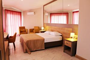 a hotel room with a bed and a mirror at Ferah Hotel in Patara +83 photos