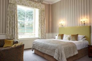 a bedroom with a large bed and a window at The Royal Hotel in Ventnor