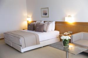 a bedroom with a large white bed and a table at ON'LIVE HOTEL in Çeşme