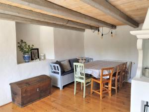 a living room with a table and chairs and a couch at Guesthouse at Isola Gård on the middle of Öland in Färjestaden