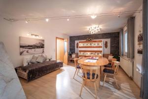 a living room with a table and a couch at Exklusiv Apartment Hofer in Sankt Johann in Tirol