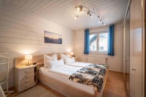 a small bedroom with a bed and a window at Exklusiv Apartment Hofer in Sankt Johann in Tirol
