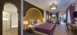 1 dormitorio con 1 cama y 1 habitación con escritorio en Alaaddin Beach Hotel - Adult Only, en Alanya