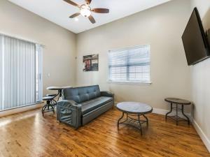 a living room with a couch and a tv at Beautiful Condos Steps from French Quarter and Bourbon St in New Orleans