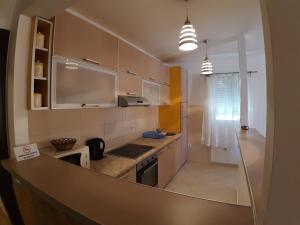 a kitchen with white cabinets and a counter top at Apartmani Jovan in Budva