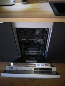 an open microwave oven sitting on top of a counter at Appartement Rue Haute des Bains in Le Croisic