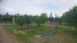 a bunch of slides in the grass in front of a building at Paljakka Villas in Kotila