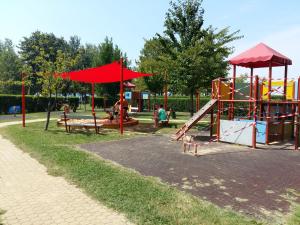 a park with a playground with a slide at Wellapartman Zamárdi in Zamárdi