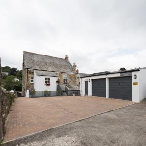 a detached house with a garage and a driveway at Cliftons Guest House in Truro +16 photos