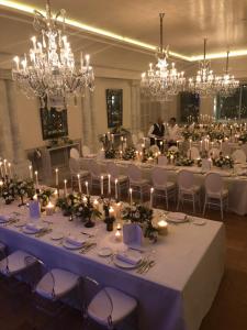 a long table with candles in a room with chandeliers at Dar El Jeld Hotel and Spa in Tunis