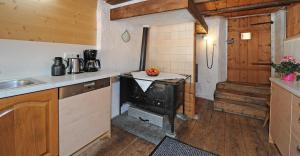a kitchen with a stove in a room at Ferienhaus Wella in Holzgau