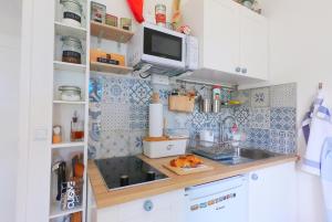 a small kitchen with a sink and a microwave at Beachfront Apartment Mala Tereza in Split