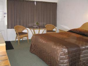 Postel nebo postele na pokoji v ubytování Coachman Motel