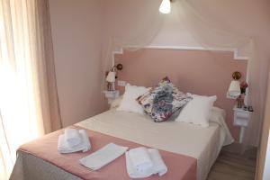 a bedroom with a bed with two towels on it at Emperador Augusto in Mérida