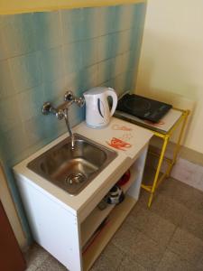 a small bathroom with a sink and a cup on it at Kuća Anka in Herceg-Novi