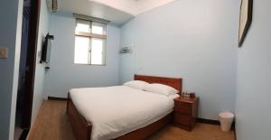 En eller flere senger på et rom på JiuZhiAn Apartment