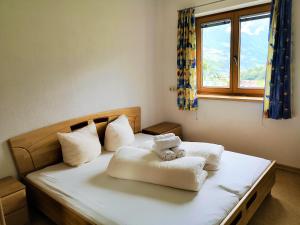 a bedroom with a bed with a teddy bear on it at Smart Chalet Ladis in Ladis