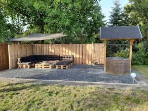 a backyard with a gazebo and a couch and a shelter at Ferienwohnung Wichtelgarten in Kranenburg