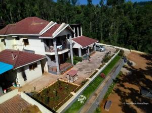 an aerial view of a house with a yard at Butter Clouds HomeStay in Chikmagalūr +33 photos