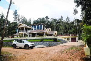 a white car parked in front of a house at Butter Clouds HomeStay in Chikmagalūr