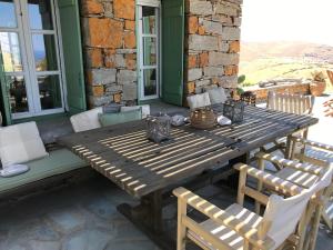 a wooden table and chairs on a patio at The Hill Top House in Kea in Ioulis +59 photos