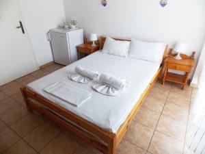 Ένα ή περισσότερα κρεβάτια σε δωμάτιο στο Ξενοδοχείο Σγουρίδης