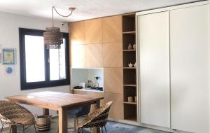 a dining room with a wooden table and chairs at Villa Spartias in Skiathos