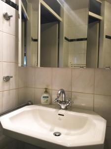 a white sink in a bathroom with a mirror at B&B Looier in Amsterdam