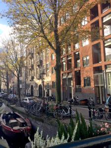 a group of bikes parked next to a canal with buildings at B&B Looier in Amsterdam