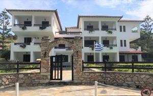 a white building with an arch in front of it at Villa Spartias in Skiathos