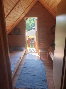 a attic room with a bed and a window at Domki nad Sanem in Lesko