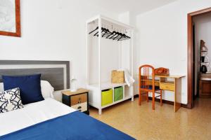 a bedroom with a bed and a desk and a chair at TorreNueva in Zaragoza