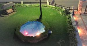 a garden with a fire pit in the grass at Villa Spartias in Skiathos