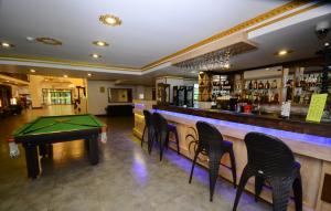 a bar with a ping pong table and chairs at Sputnik Hotel Batumi in Batumi