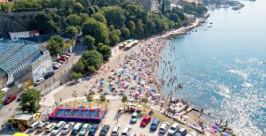 an aerial view of a beach with people and umbrellas at Apartment Anita 1 in Rijeka