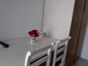 a white table with a vase of flowers on it at B&B Casa Torre -Amalficoast room in Agerola