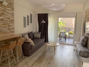 a living room with a couch and a table at Litsa Apartments in Fourka