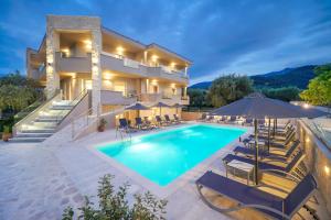 a villa with a swimming pool at night at Iliomagic Luxury Suites Thassos in Limenas