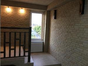 a hallway with a brick wall and a window at Moonlight Hotel in Chişinău