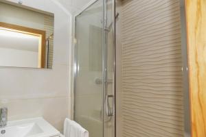 un bagno con doccia e lavandino di Casa Encosta do Rio-ferias no Gerês a Vieira do Minho Altre 10 foto