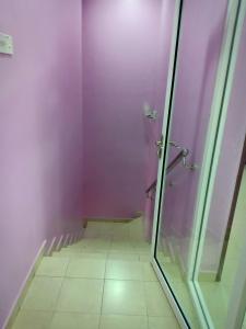 a bathroom with a shower with purple walls at Purple TownHouse 3R2B Wifi in Sekincan