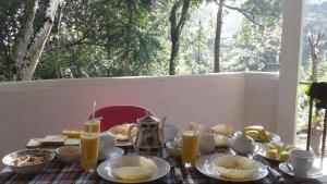 a table with food and drinks on top of it at Ella Mount Villa in Ella