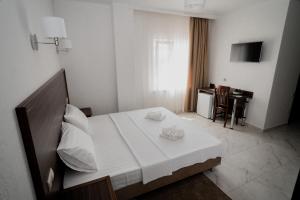 a bedroom with a large white bed in a room at Hotel Samson in Sukhum