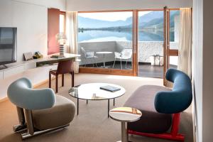 a living room with a view of the water at Seehotel Ambach in Caldaro