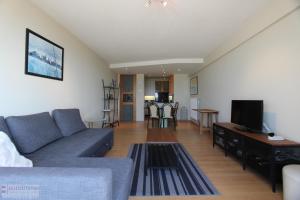 a living room with a couch and a tv at Westhinder apt 301 in Nieuwpoort