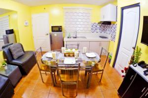 a living room with a dining room table and a kitchen at ARC 2219 Home Rentals 2BR in Cebu City