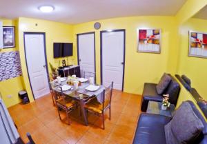 sala de estar con mesa y sofá en ARC 2219 Home Rentals 2BR en Cebú
